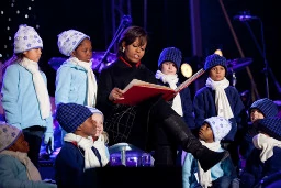 image of michelle obama reading book to audience
